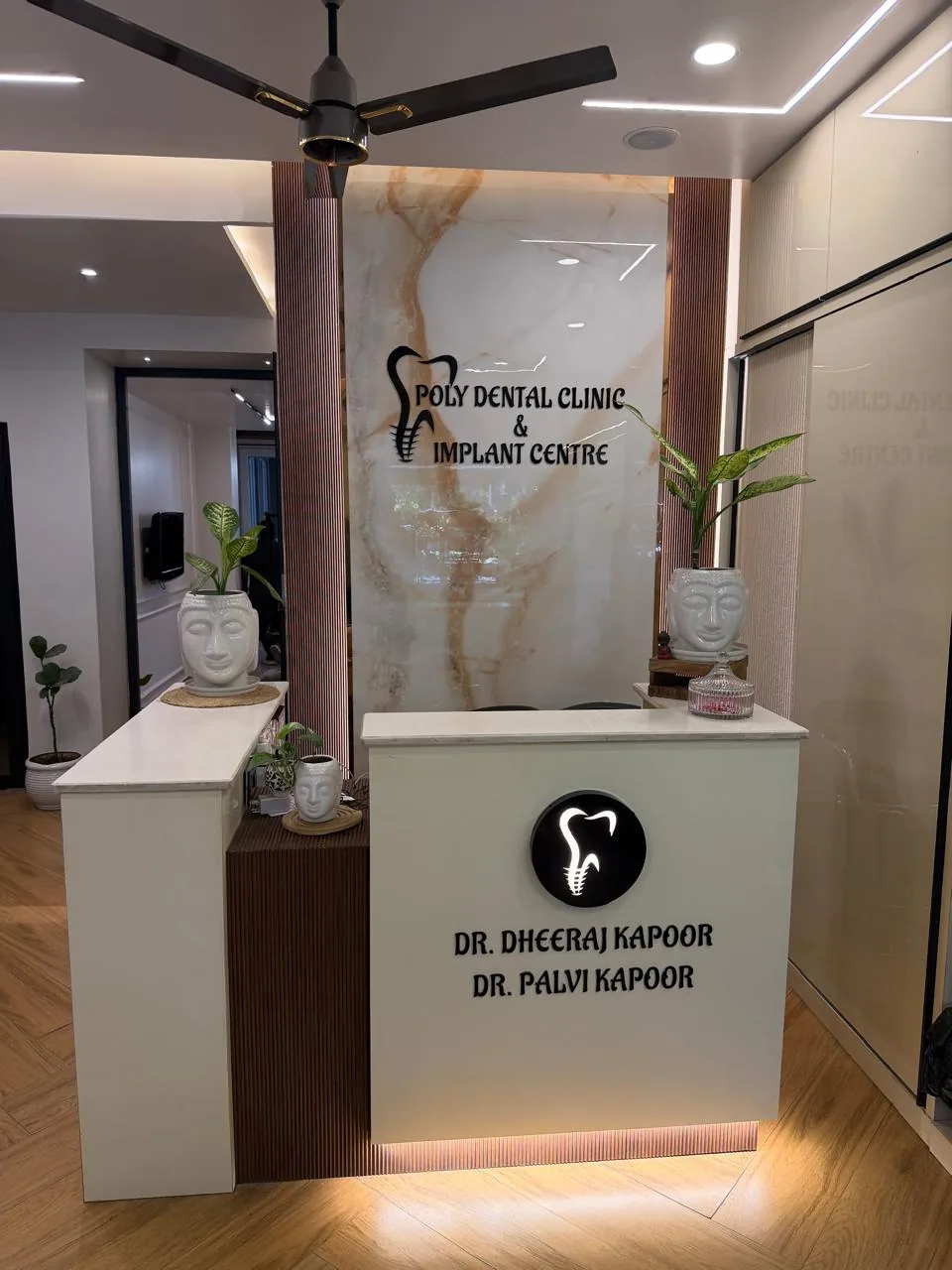 Reception desk at Poly Dental Clinic Mohali with Dr. Dheeraj Kapoor and Dr. Palvi Kapoor branding